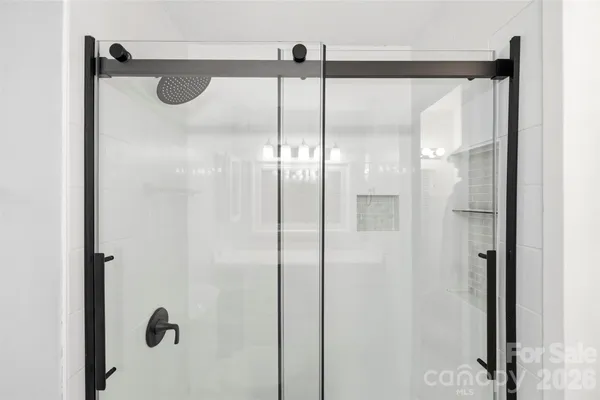 a bathroom with a glass shower door