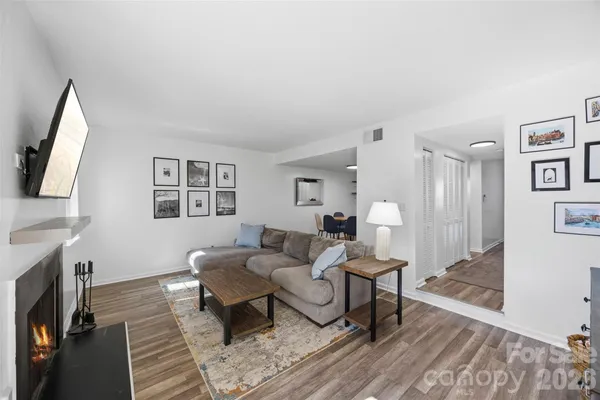 a living room with furniture a fireplace and a flat screen tv