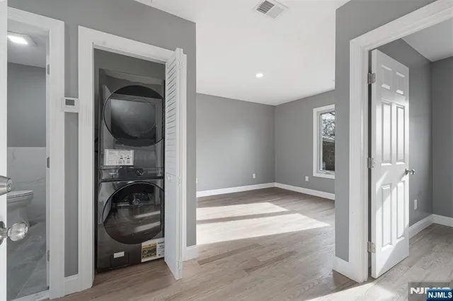 a view of a hallway and a livingroom with wooden floor