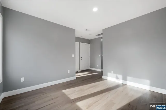 a view of a room with wooden floor