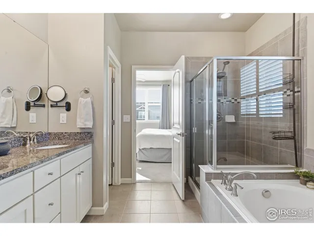 a bathroom with a granite countertop sink mirror and shower