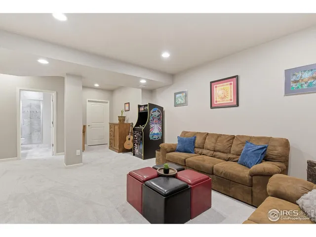 a living room with furniture kitchen view and a couch