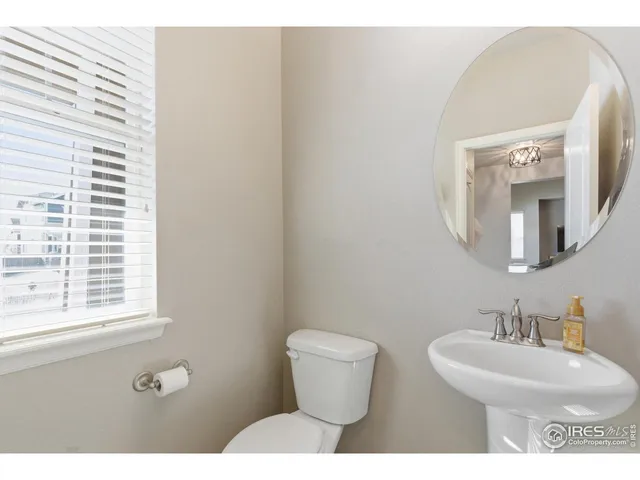 a bathroom with a toilet a sink and a mirror