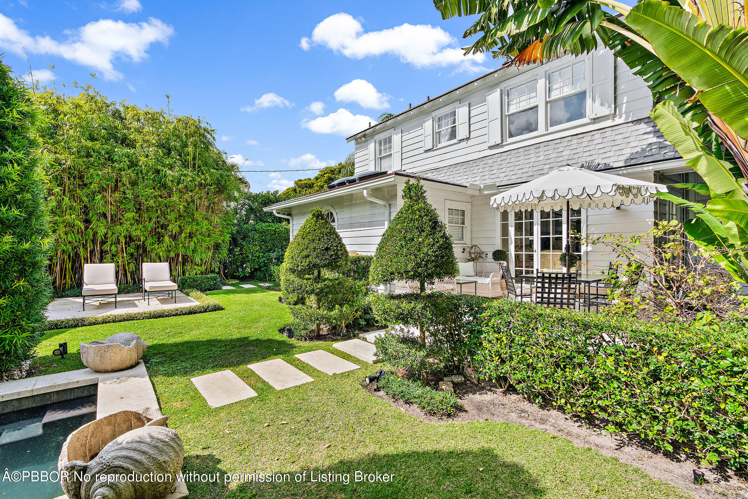 204 Westminster Road West Palm Beach, FL 33405 - Photo 11 of 16 a front view of a house with swimming pool having outdoor seating