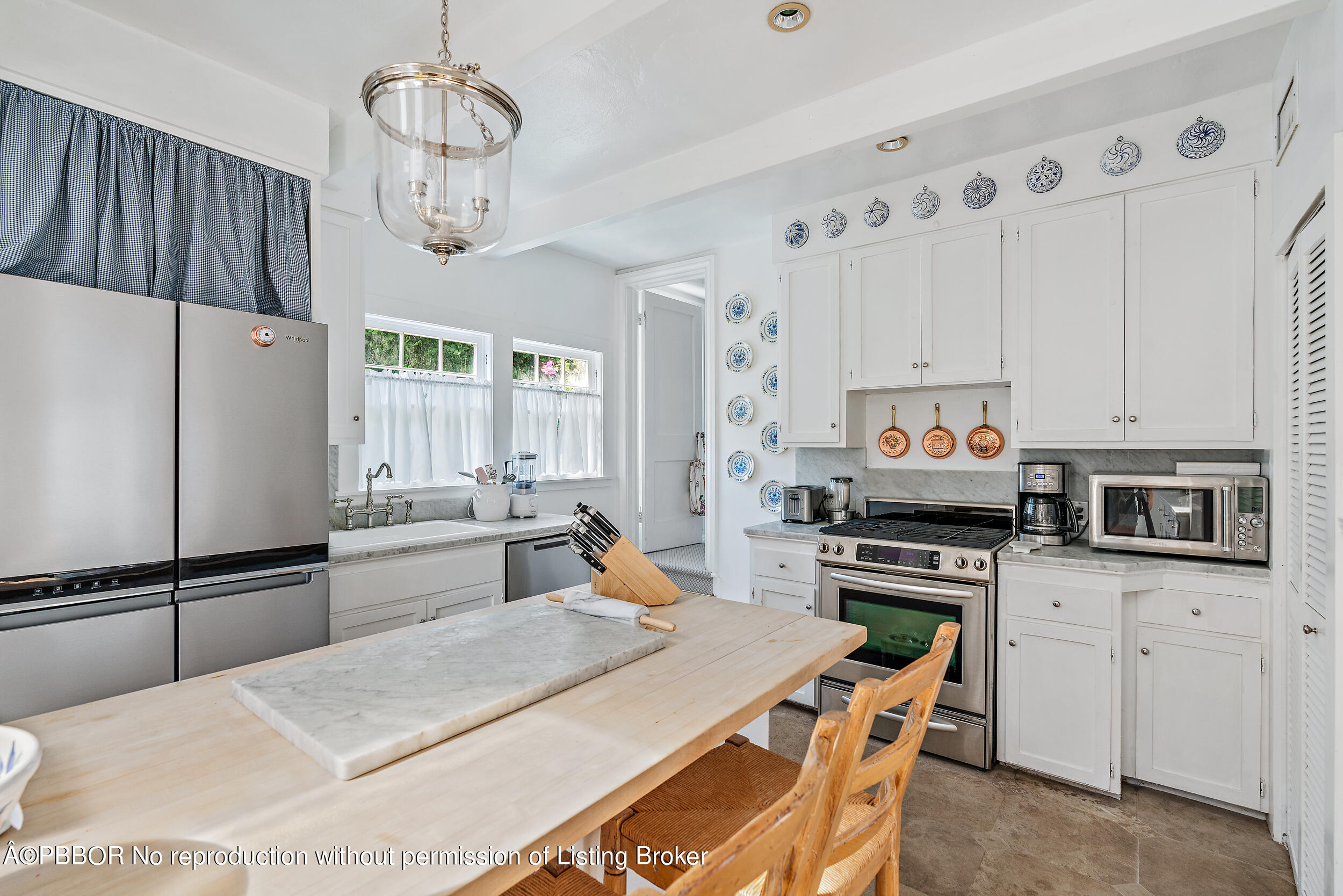 204 Westminster Road West Palm Beach, FL 33405 - Photo 5 of 16 a kitchen with stainless steel appliances a stove refrigerator sink and cabinets