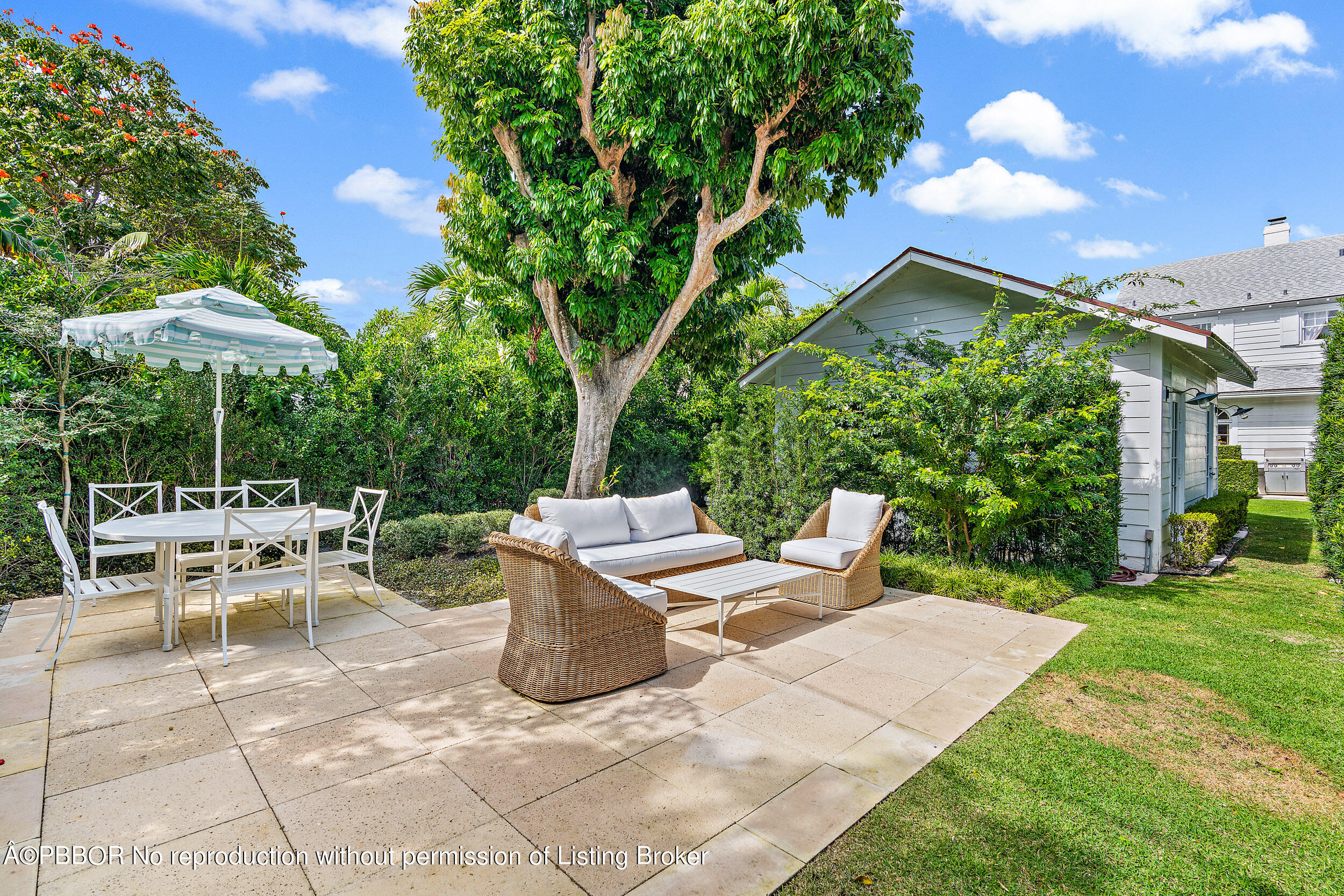 204 Westminster Road West Palm Beach, FL 33405 - Photo 10 of 16 a view of a patio with table and chairs under an umbrella