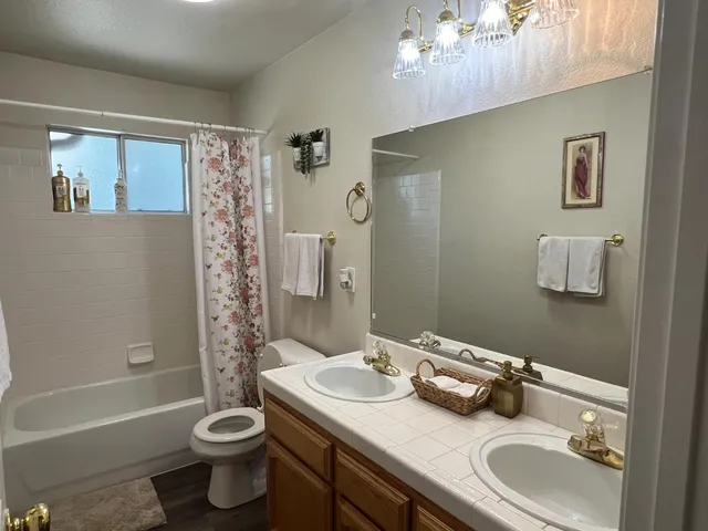 a bathroom with a sink toilet and shower