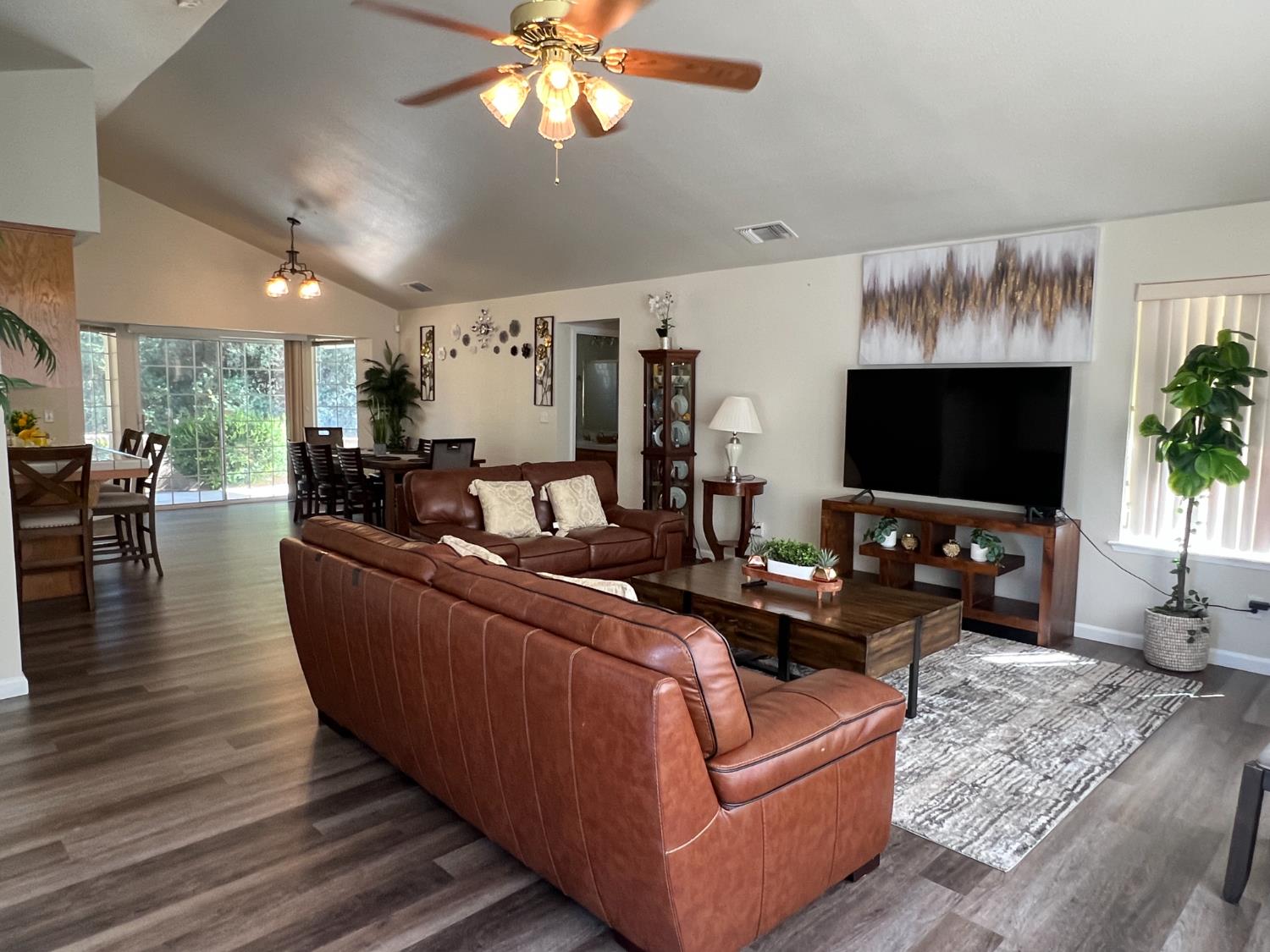 50613 Granite Butte Way Oakhurst, CA 93644 - Photo 2 of 31 a living room with furniture and a flat screen tv