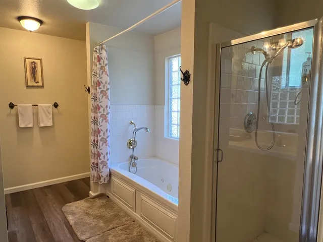 a bathroom with a bathtub and a shower
