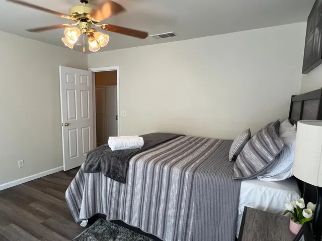 a bedroom with a bed and a chandelier