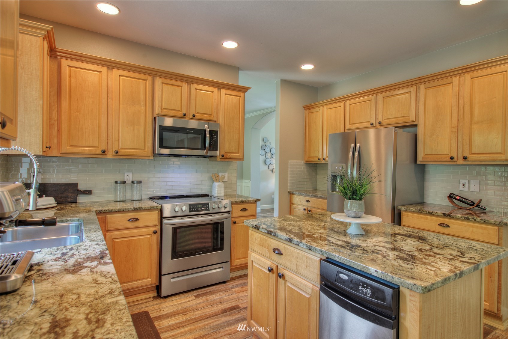 1127 R Street Northwest Auburn, WA 98001 - Photo 13 of 37 a kitchen with stainless steel appliances granite countertop a stove top oven a sink dishwasher and a refrigerator with wooden cabinets