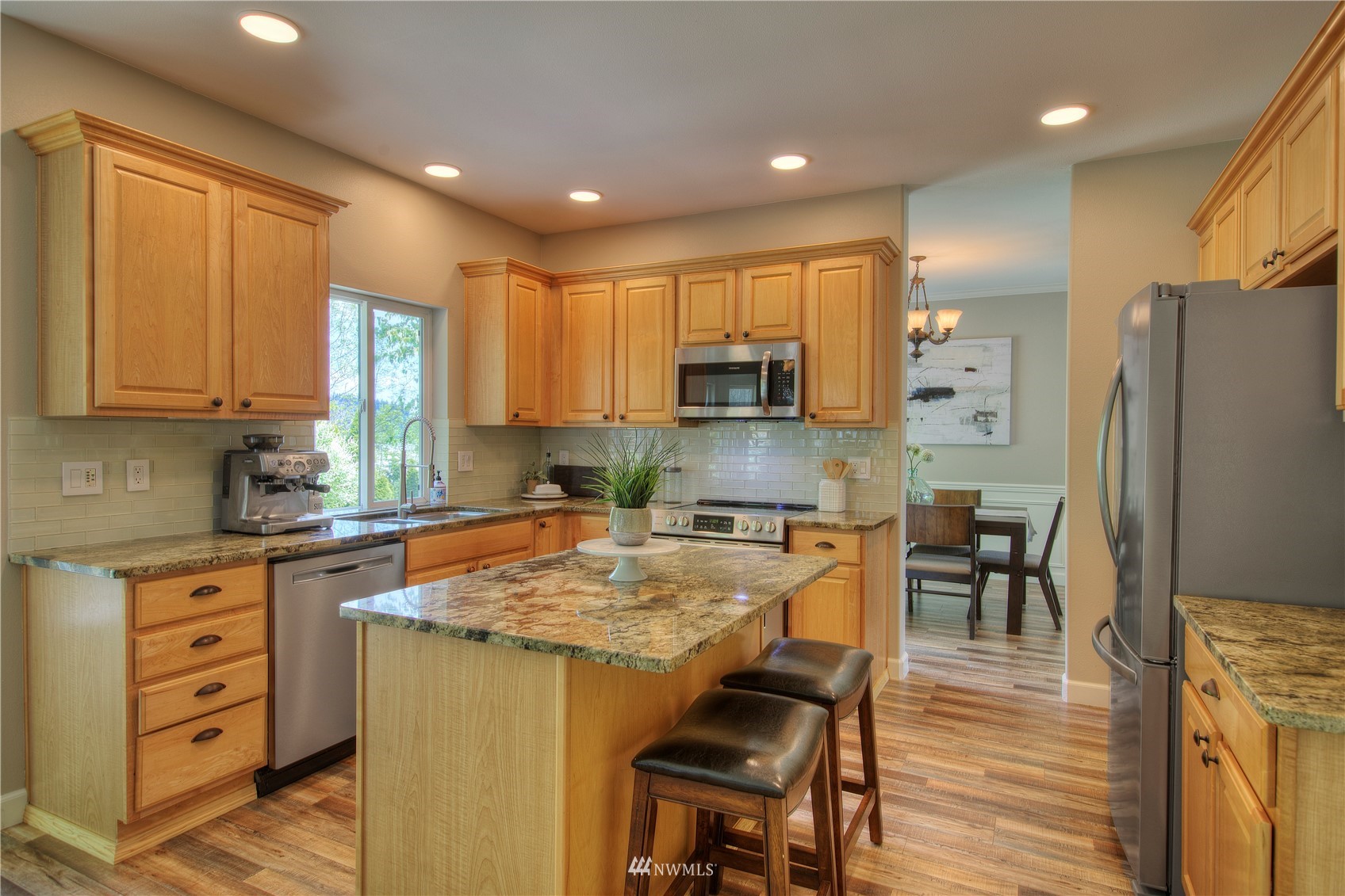 1127 R Street Northwest Auburn, WA 98001 - Photo 14 of 37 a kitchen with stainless steel appliances granite countertop a stove top oven a refrigerator a sink and chairs