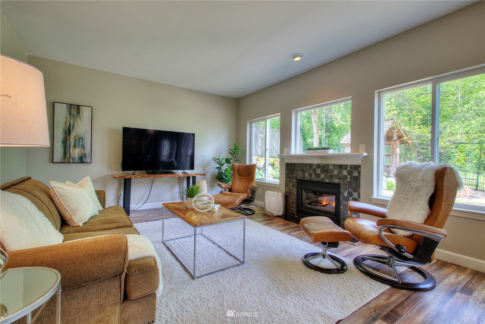 1127 R Street Northwest Auburn, WA 98001 - Photo 16 of 37 a living room with furniture a fireplace and a flat screen tv