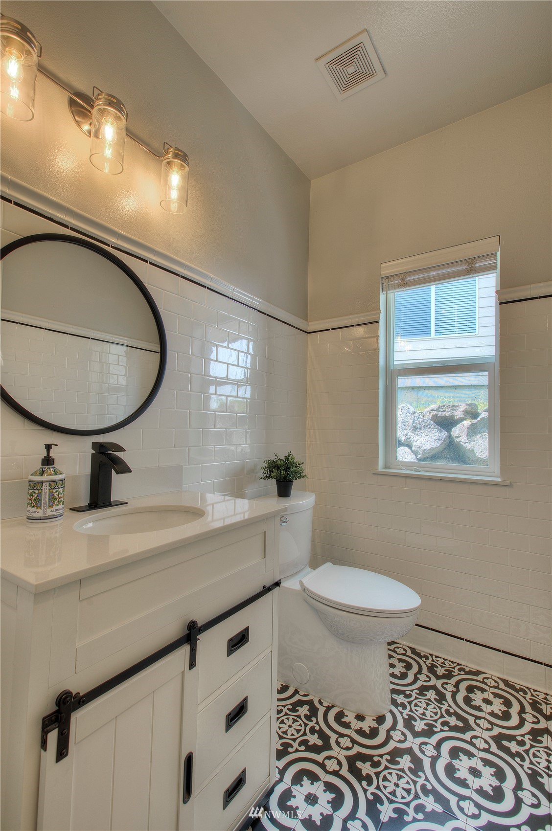 1127 R Street Northwest Auburn, WA 98001 - Photo 19 of 37 a bathroom with a sink a toilet and a mirror