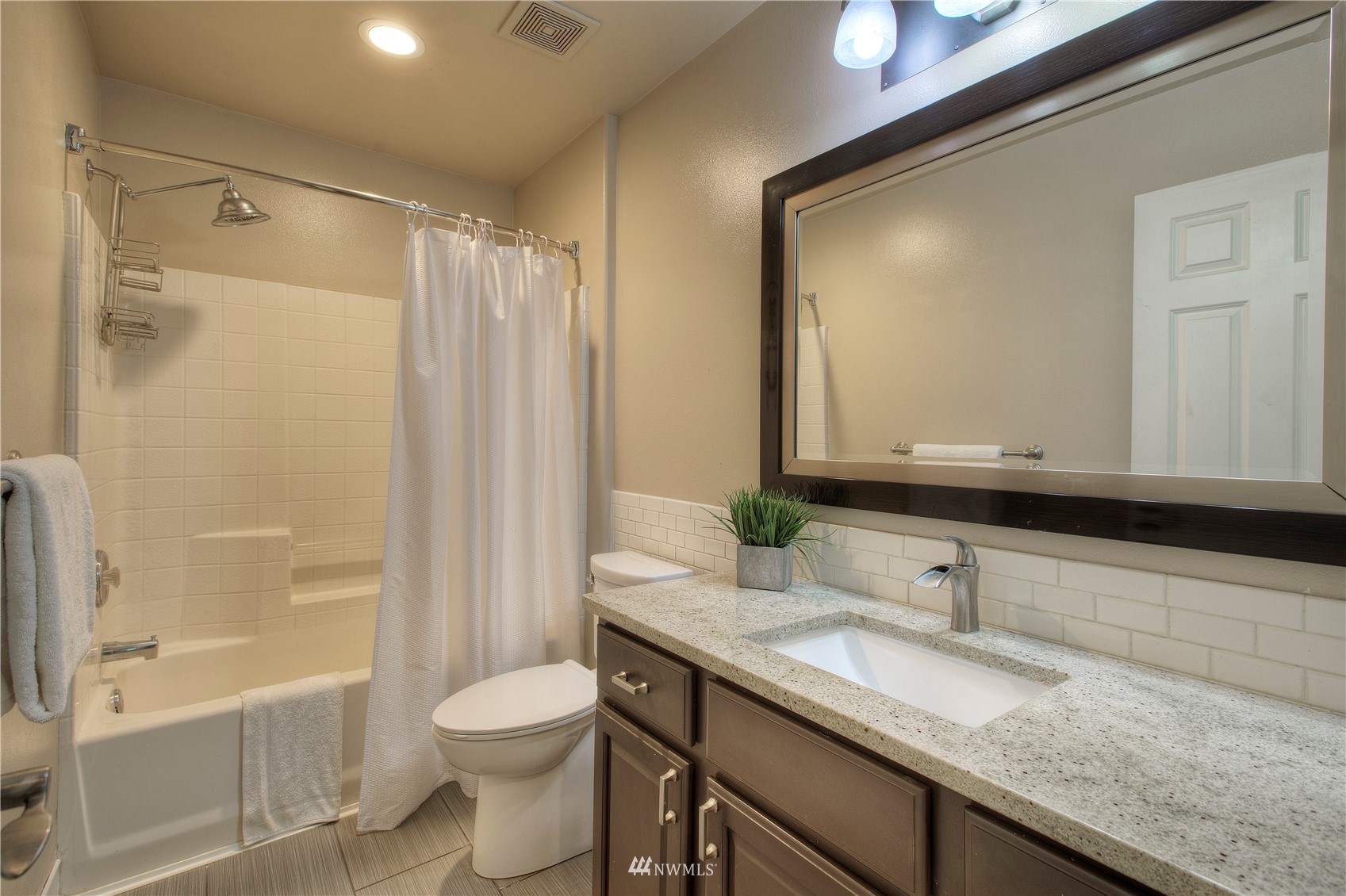 1127 R Street Northwest Auburn, WA 98001 - Photo 27 of 37 a bathroom with a granite countertop sink toilet and shower