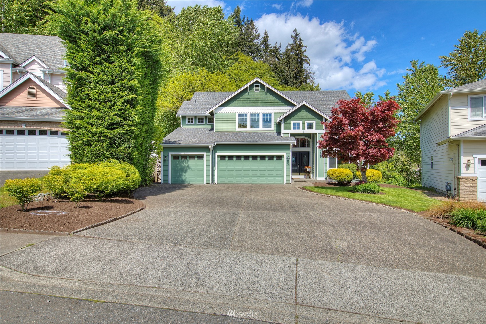 1127 R Street Northwest Auburn, WA 98001 - Photo 3 of 37 a front view of a house with a yard and garage