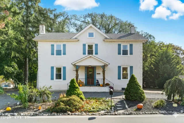 a front view of a house with garden