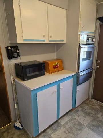 a kitchen with a refrigerator stove and cabinets