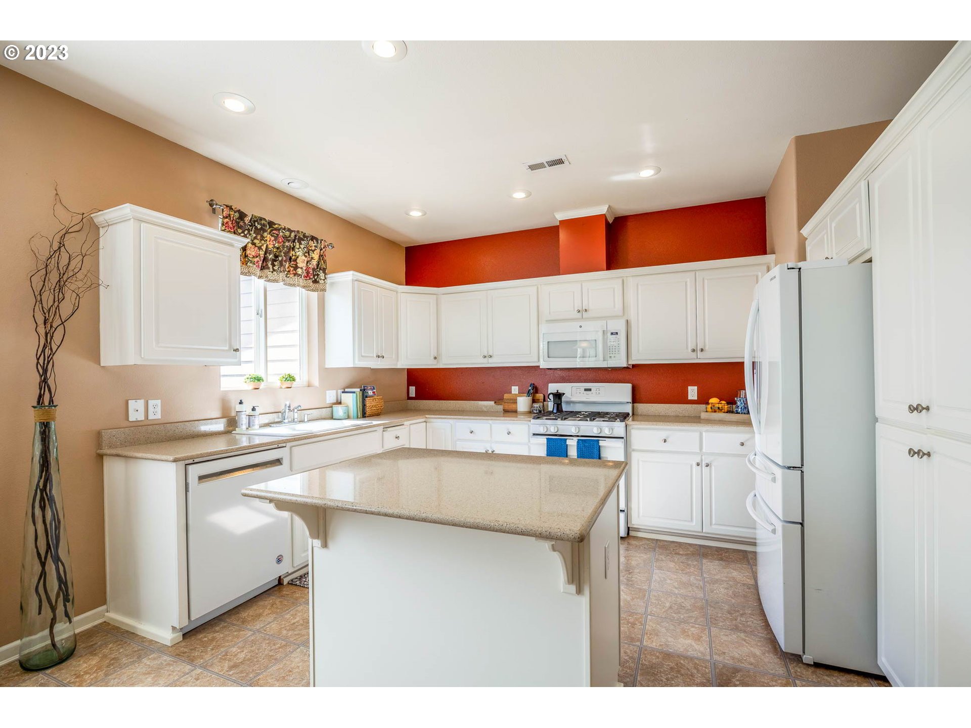 5408 Jeffrey Way Eugene, OR 97402 - Photo 7 of 37 a kitchen with stainless steel appliances a sink a stove a refrigerator cabinets and a dining table