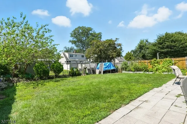 a view of a garden with a house