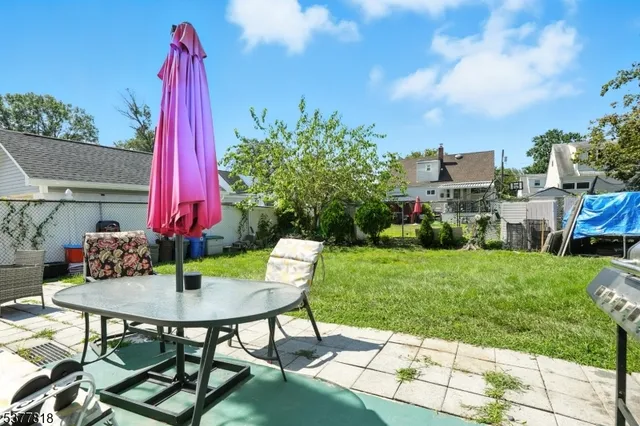 a view of a backyard with table and chairs and potted plants