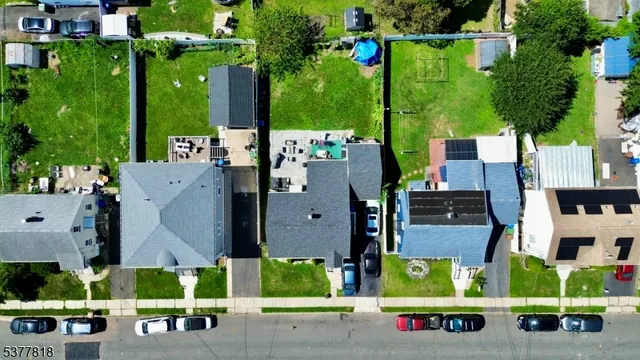 an aerial view of multiple houses with yard