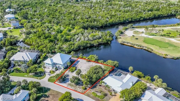 an aerial view of a house a yard and a pond