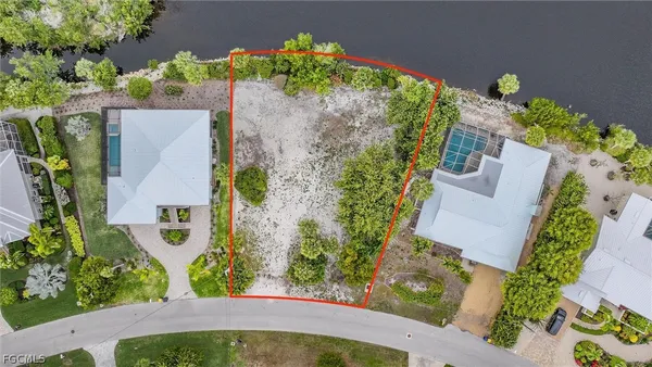 an aerial view of a house with a yard and garden