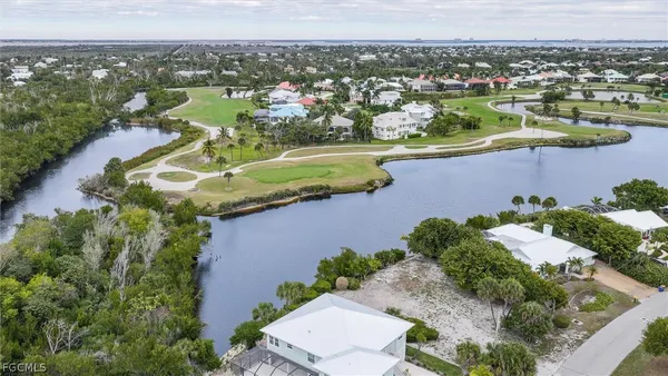 an aerial view of lake and residential houses with outdoor space
