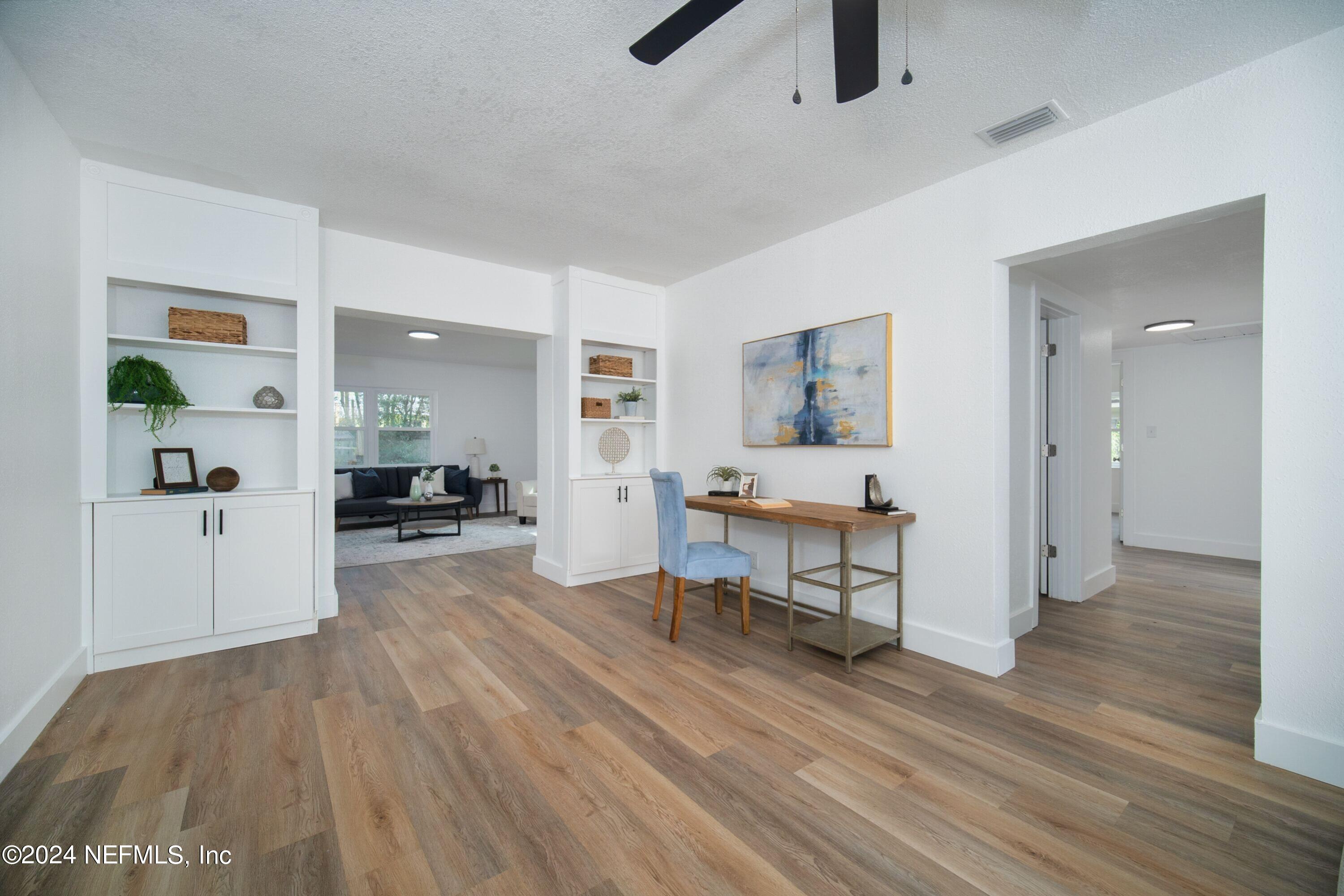 2589 Springmont Street Jacksonville, FL 32207 - Photo 11 of 71 a living room with furniture and a wooden floor