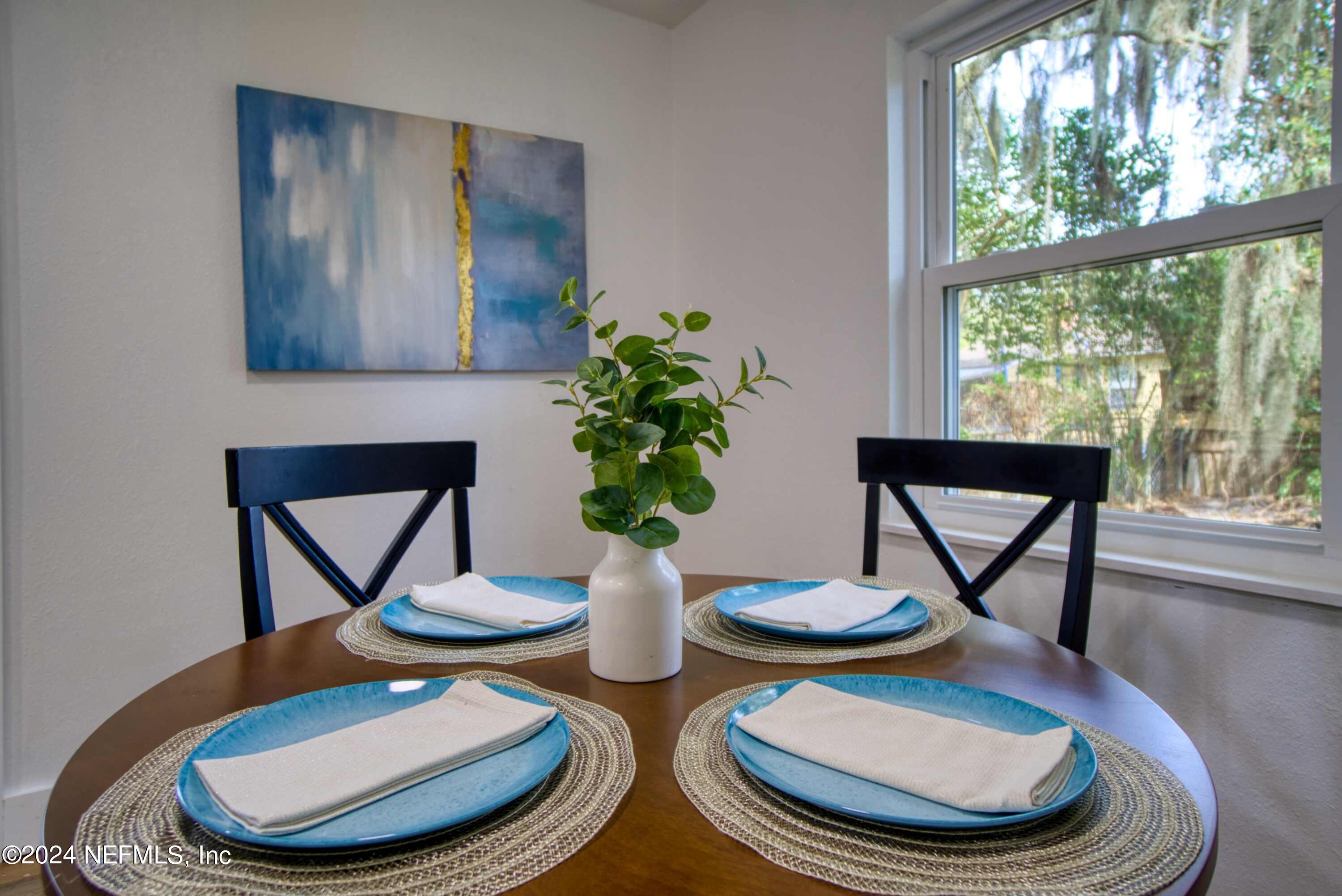 2589 Springmont Street Jacksonville, FL 32207 - Photo 24 of 71 a view of a dining room with furniture a large window and wooden floor