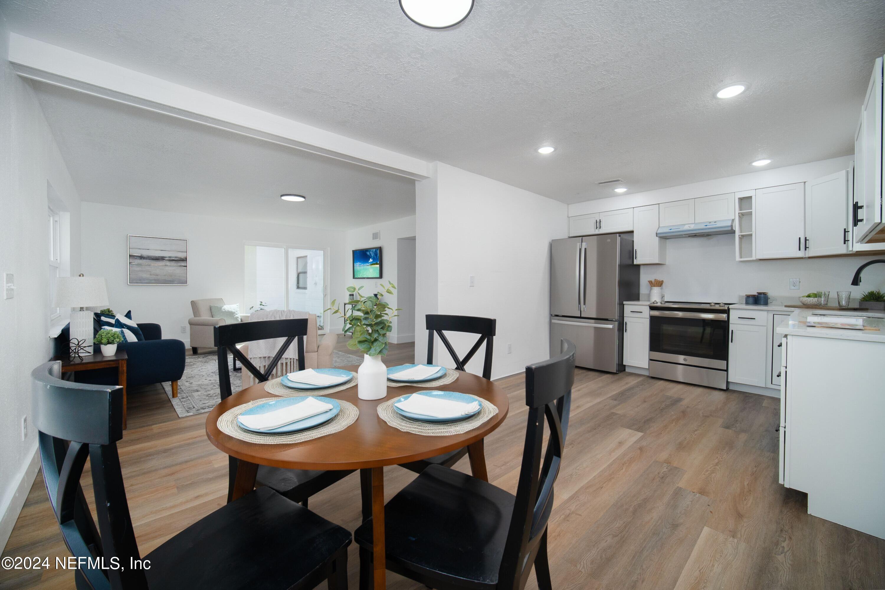 2589 Springmont Street Jacksonville, FL 32207 - Photo 25 of 71 a view of a dining room with furniture and wooden floor