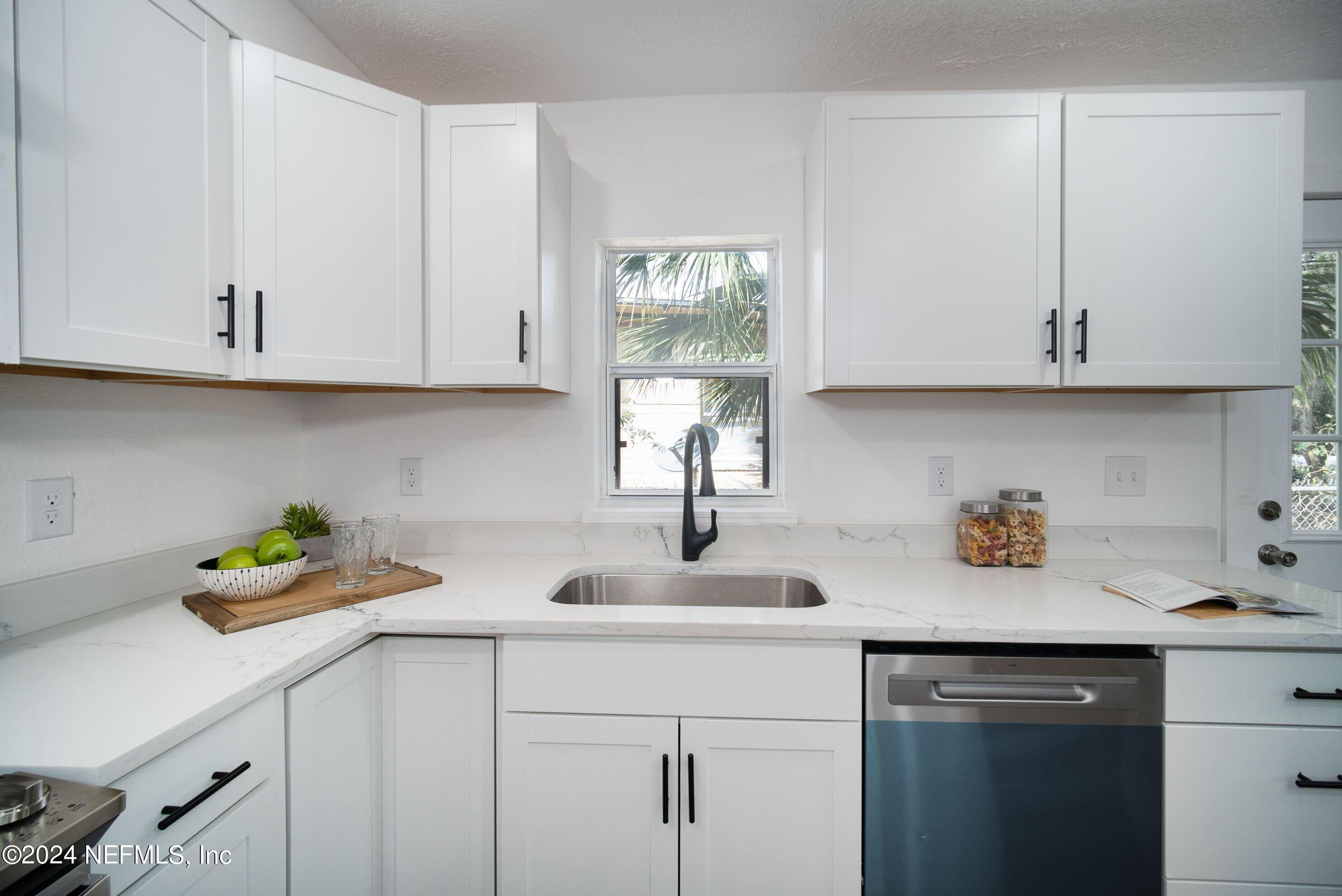 2589 Springmont Street Jacksonville, FL 32207 - Photo 29 of 71 a kitchen with white cabinets and a sink