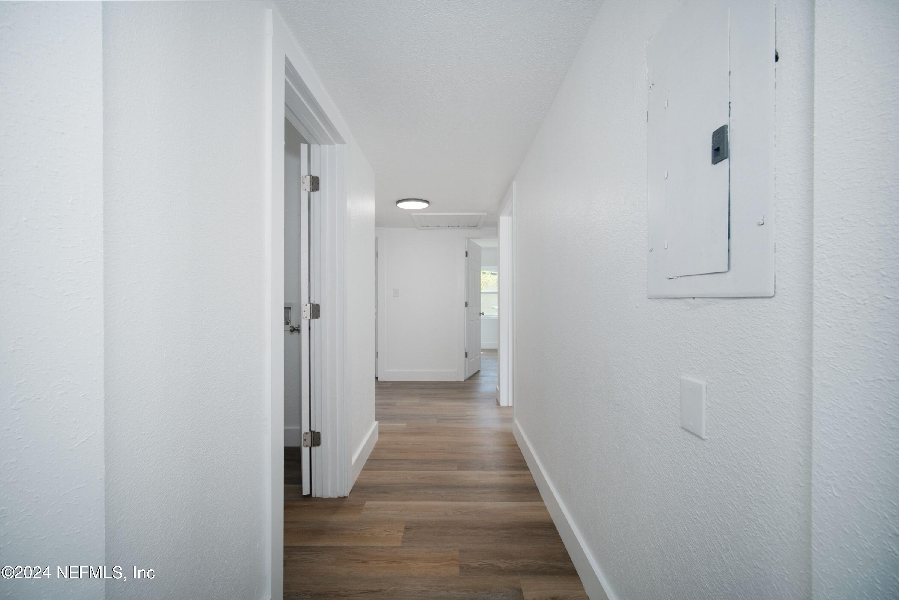 2589 Springmont Street Jacksonville, FL 32207 - Photo 33 of 71 a view of a hallway with wooden floor