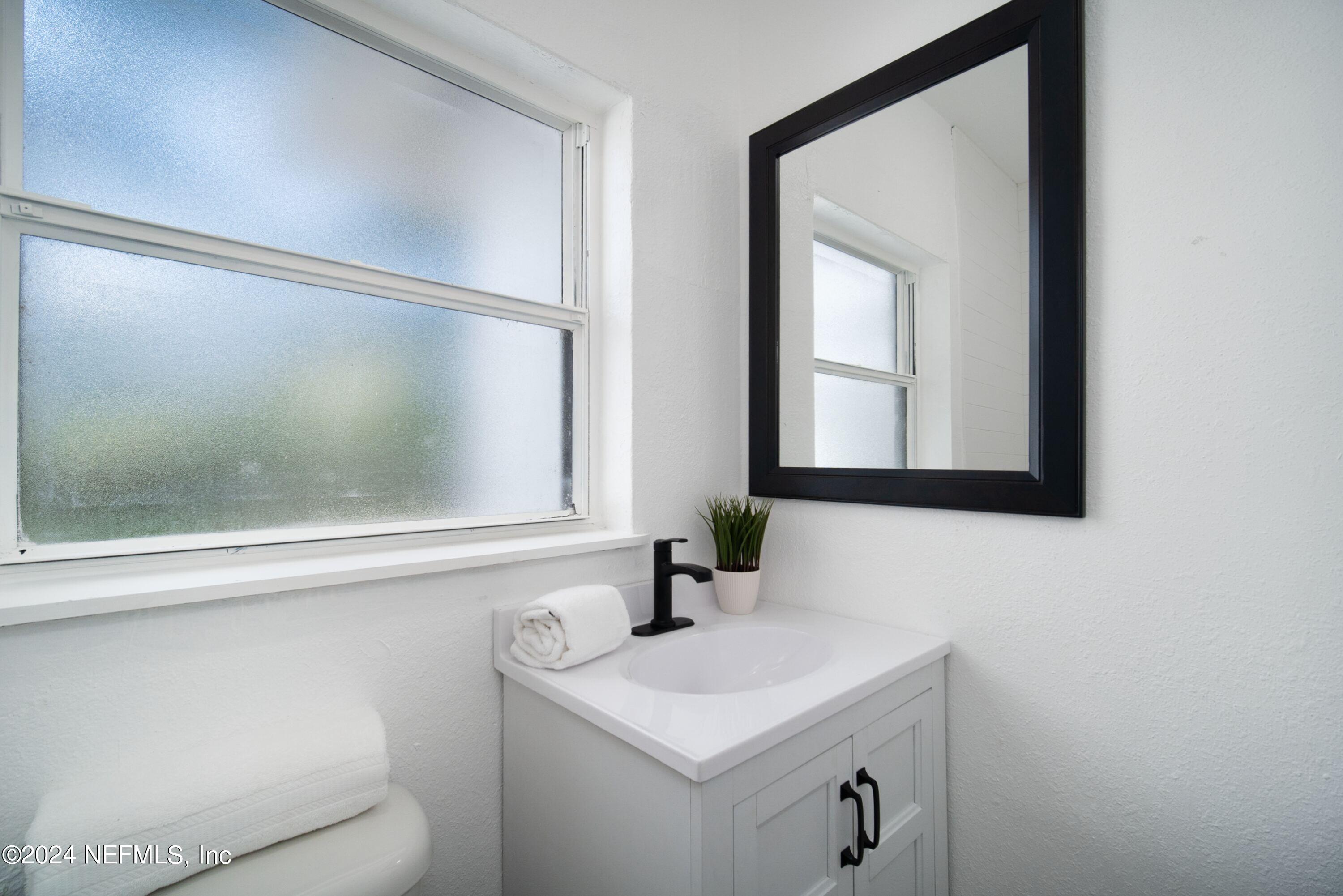 2589 Springmont Street Jacksonville, FL 32207 - Photo 35 of 71 a bathroom with a sink and a mirror
