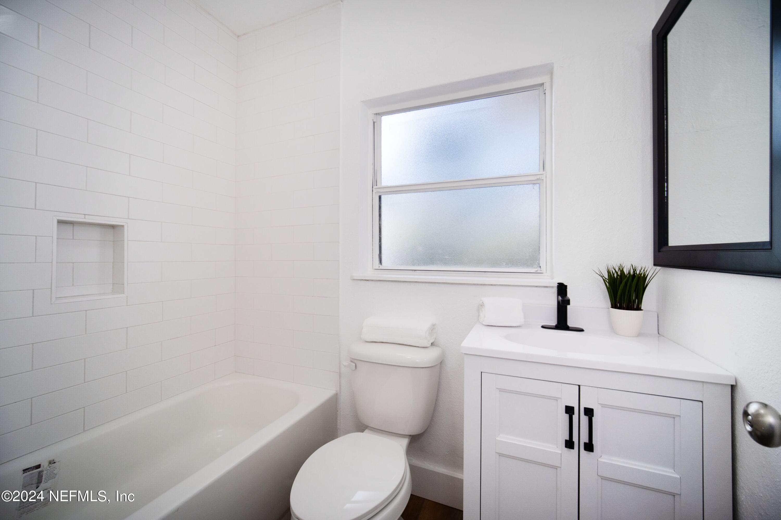 2589 Springmont Street Jacksonville, FL 32207 - Photo 36 of 71 a bathroom with a sink toilet vanity and tub