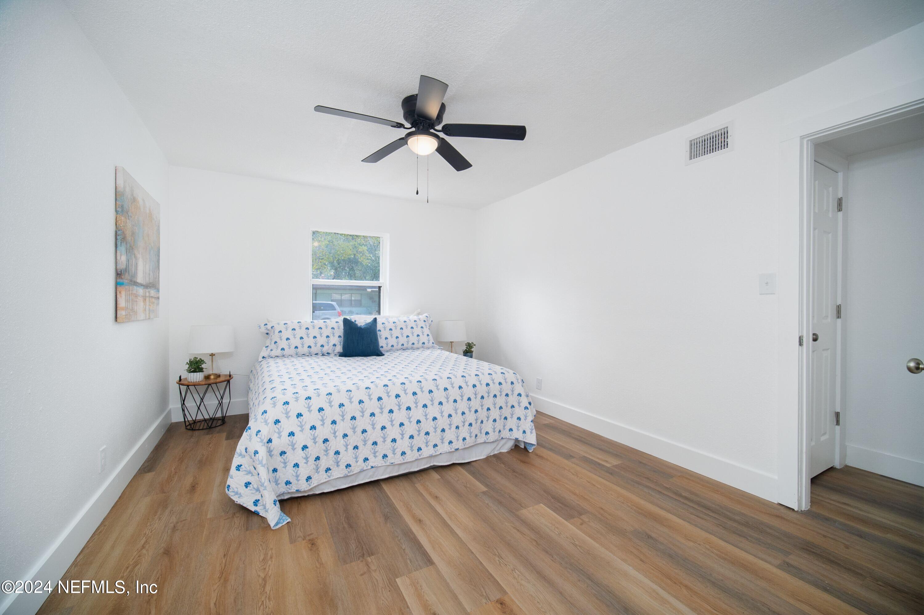 2589 Springmont Street Jacksonville, FL 32207 - Photo 38 of 71 a bedroom with a bed and wooden floor