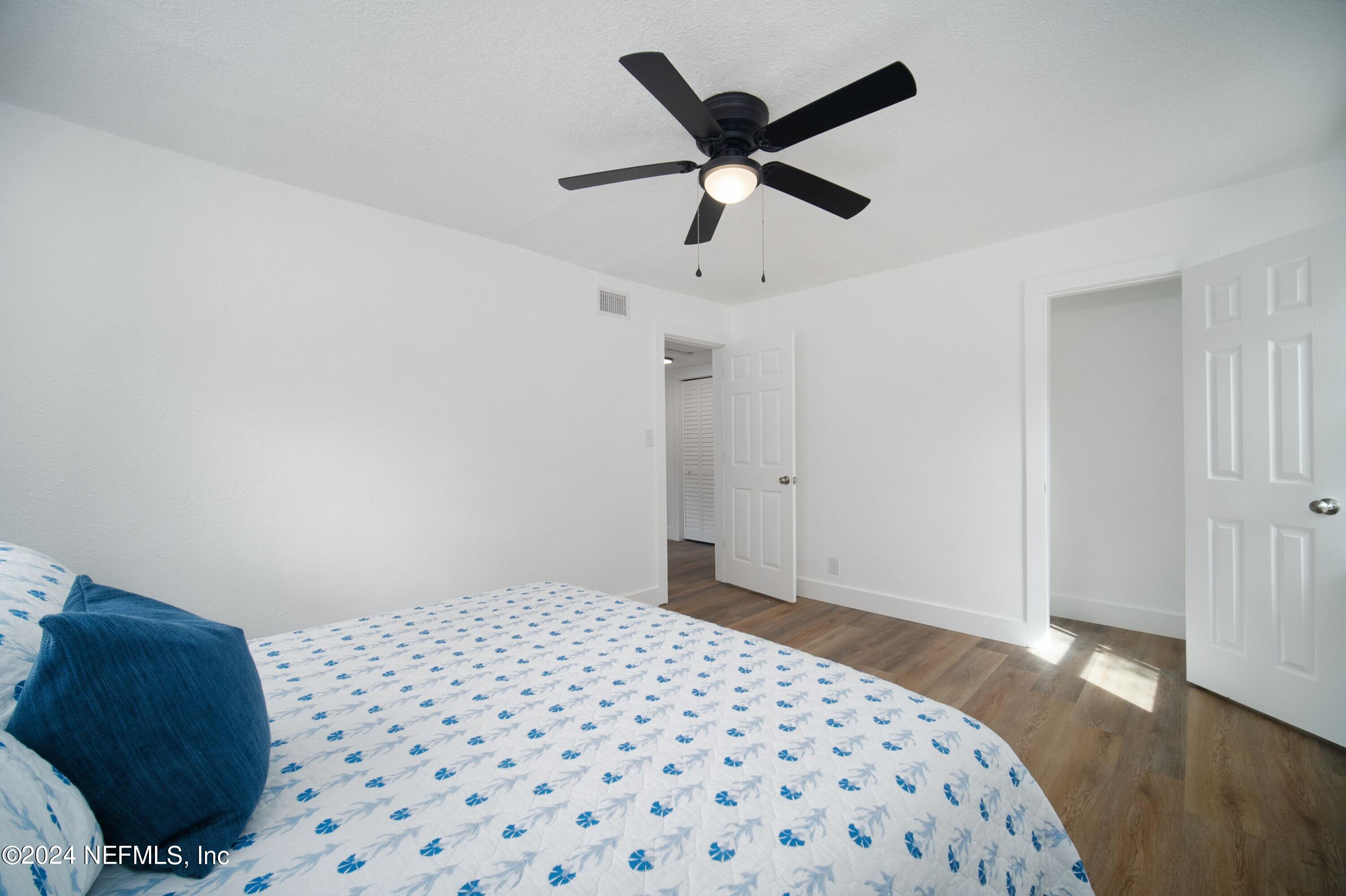 2589 Springmont Street Jacksonville, FL 32207 - Photo 39 of 71 a bedroom with a bed and wooden floor