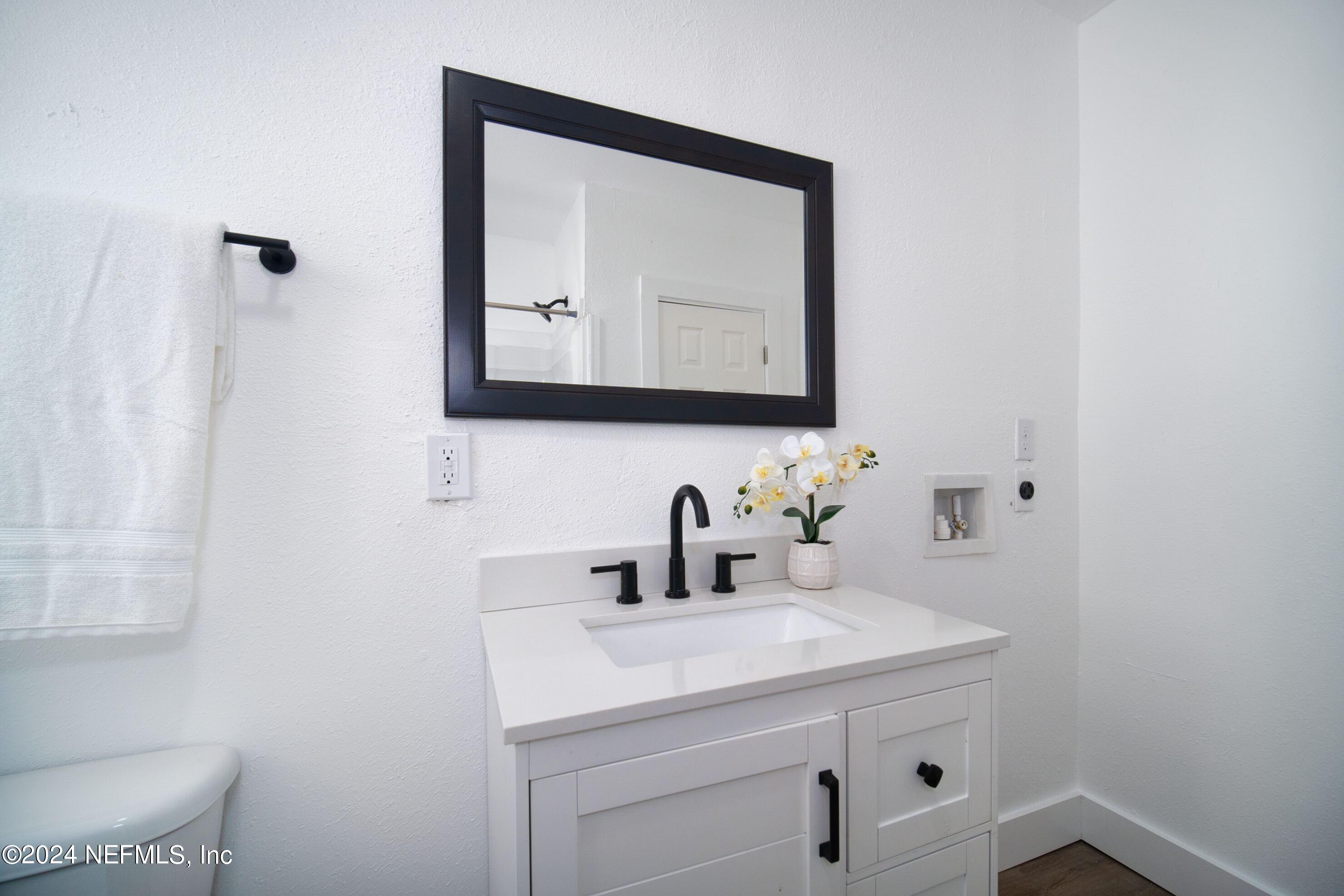 2589 Springmont Street Jacksonville, FL 32207 - Photo 43 of 71 a bathroom with a sink and a mirror
