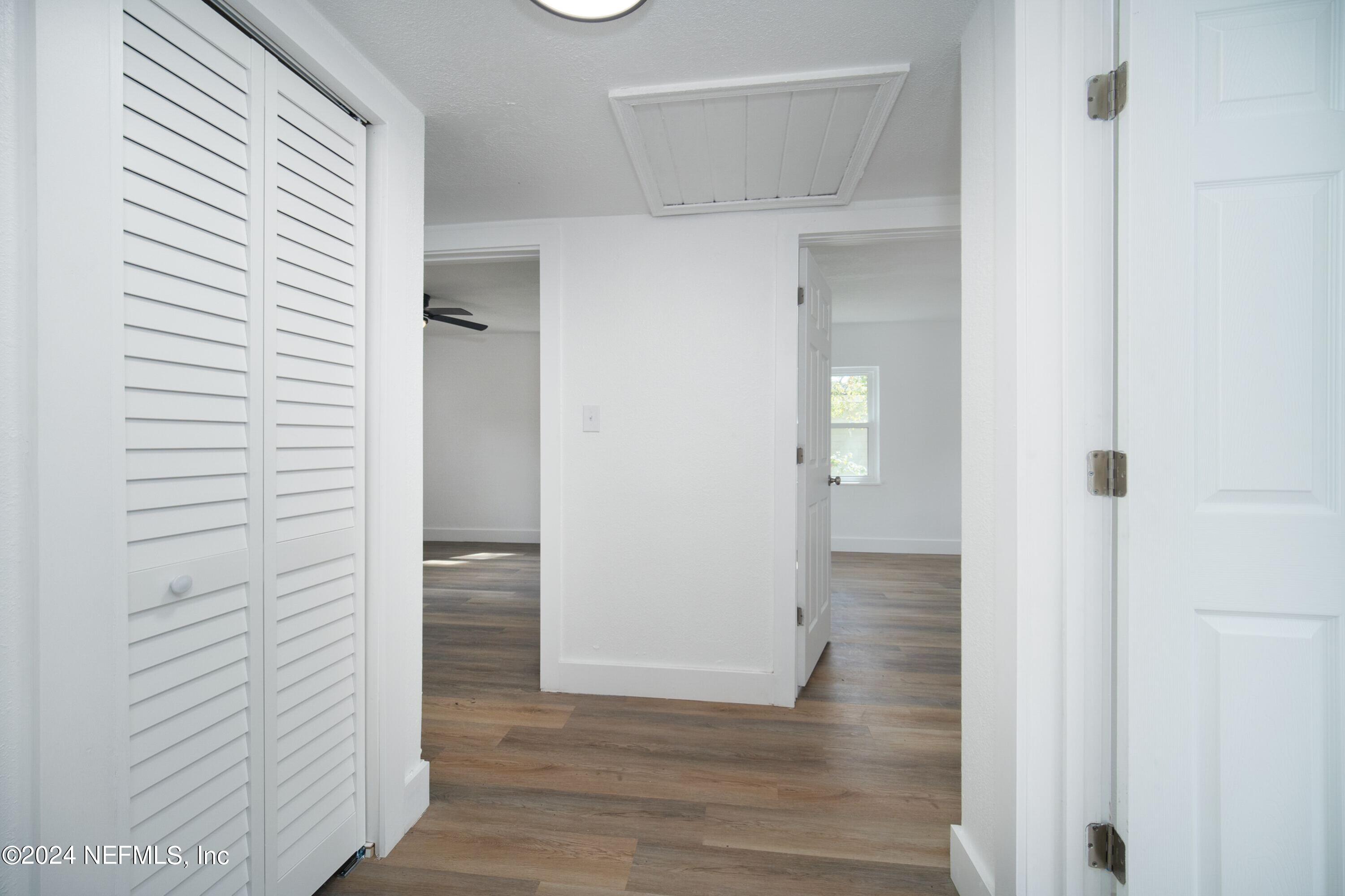 2589 Springmont Street Jacksonville, FL 32207 - Photo 44 of 71 a view of a hallway with wooden floor and closet