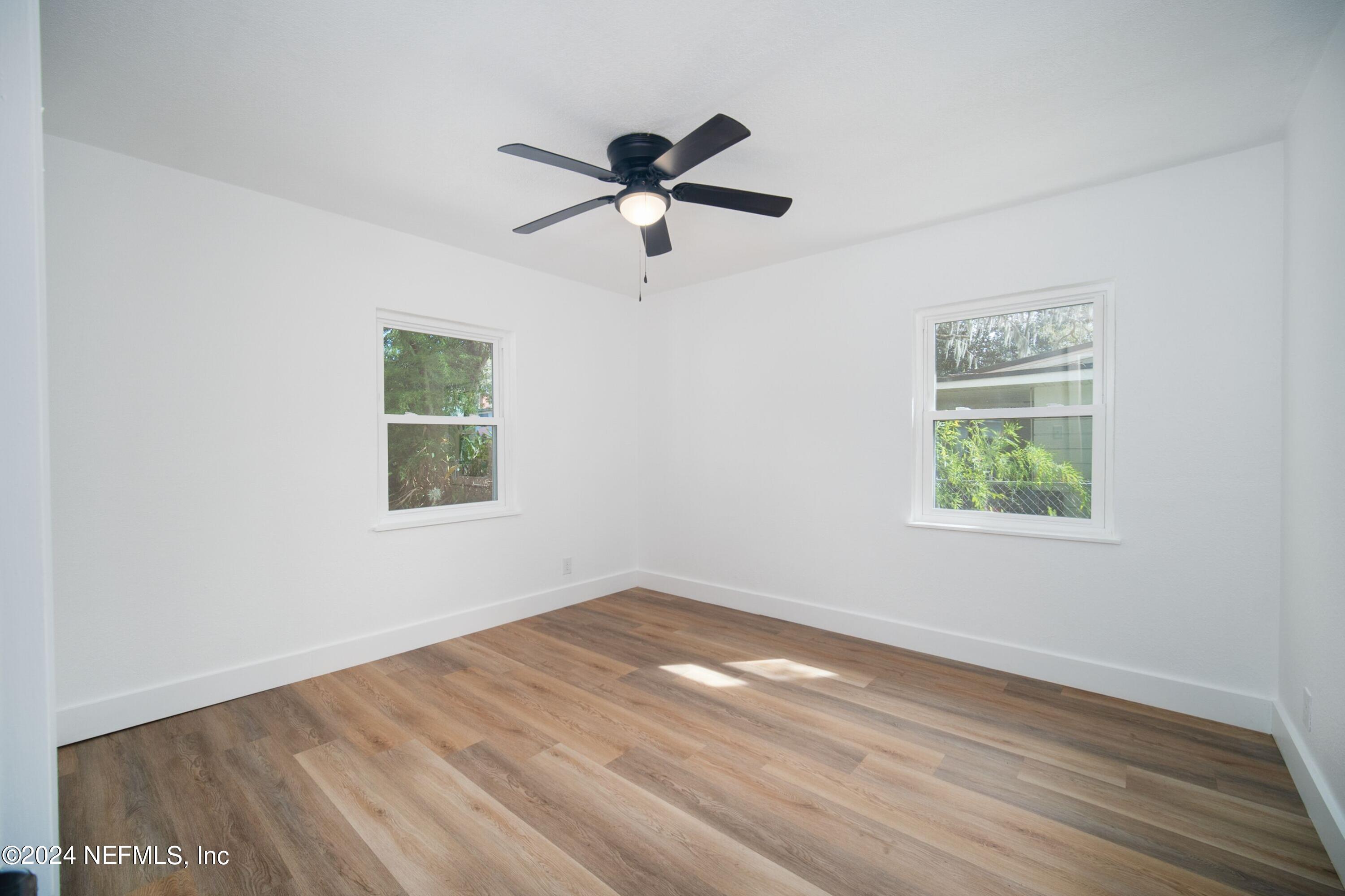 2589 Springmont Street Jacksonville, FL 32207 - Photo 46 of 71 a view of empty room with wooden floor and fan