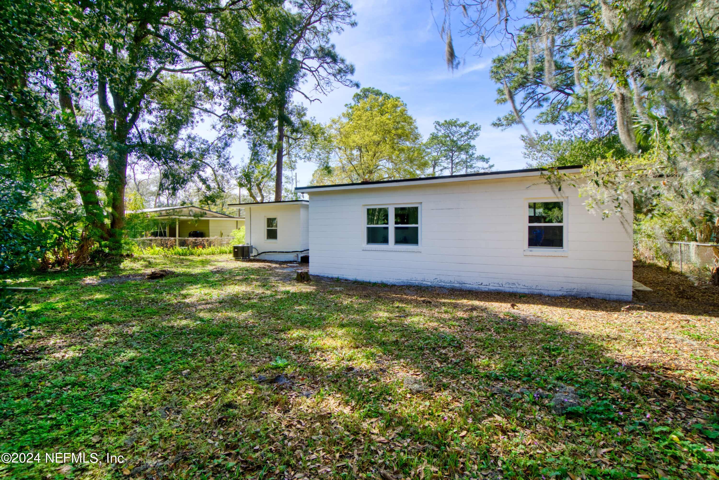 2589 Springmont Street Jacksonville, FL 32207 - Photo 59 of 71 a view of a backyard with plants and large tree