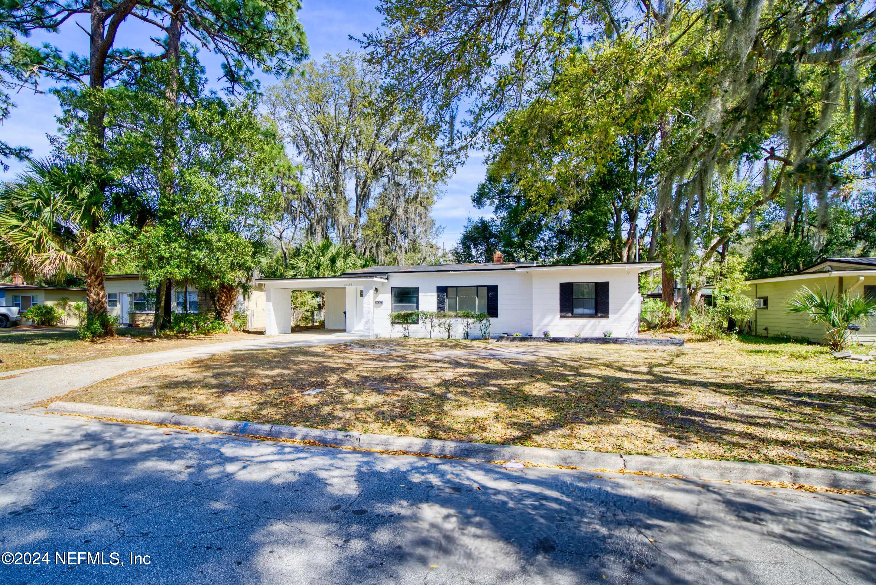 2589 Springmont Street Jacksonville, FL 32207 - Photo 67 of 71 a front view of a house with a garden