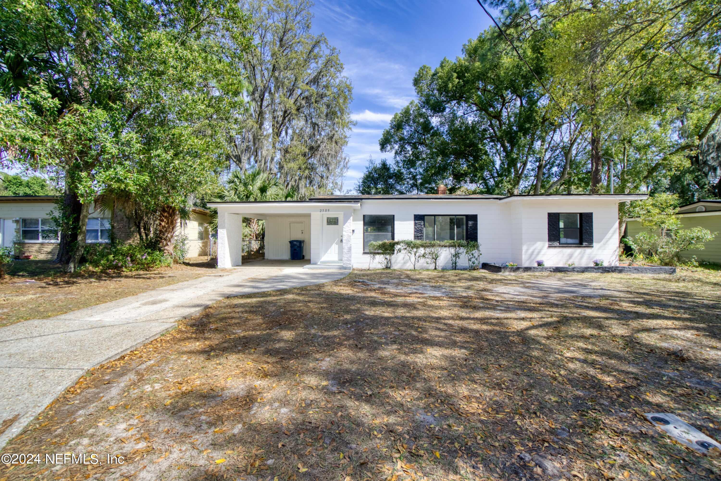 2589 Springmont Street Jacksonville, FL 32207 - Photo 69 of 71 a front view of house with yard and green space