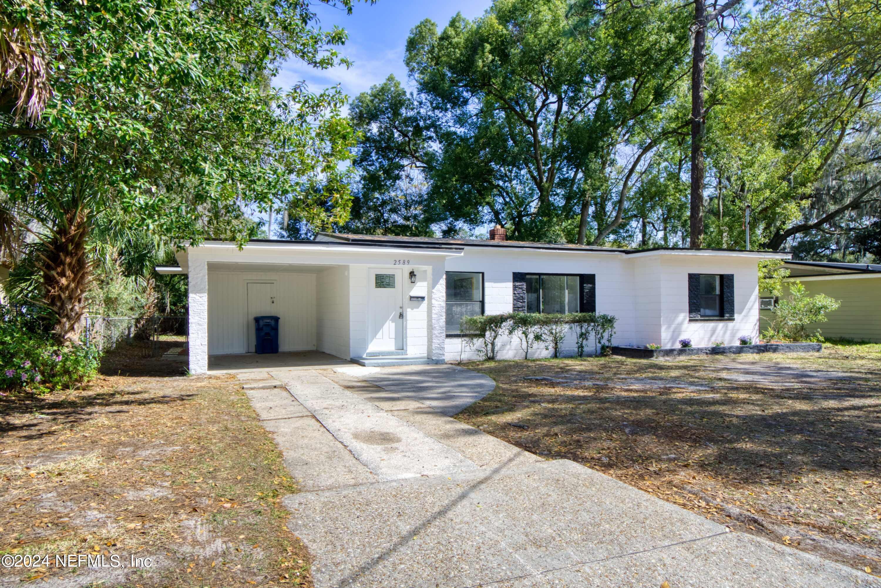2589 Springmont Street Jacksonville, FL 32207 - Photo 71 of 71 a front view of house with yard and trees