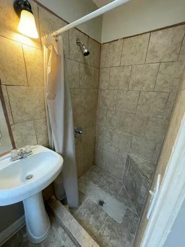 a bathroom with a toilet and a shower