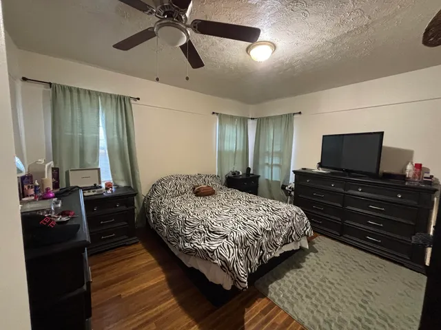 a bedroom with furniture and a wooden floor