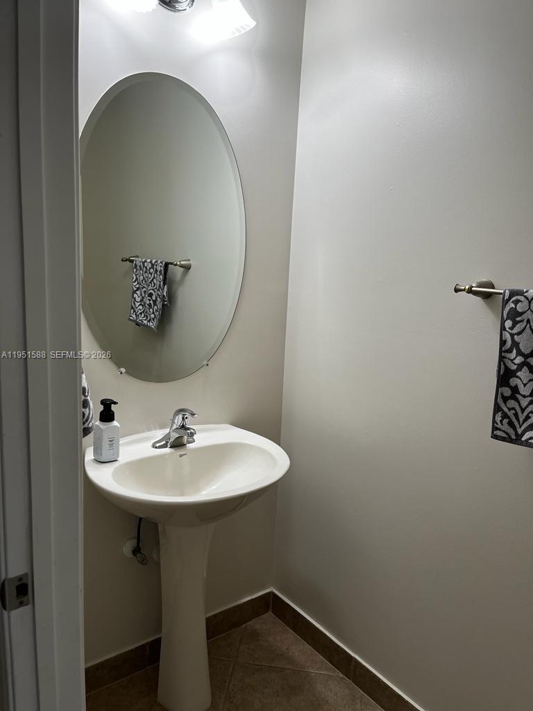 5923 Abbey Road, Unit 5923 Tamarac, FL 33321 - Photo 4 of 6 a bathroom with a sink and mirror
