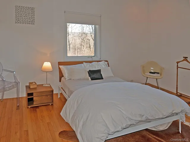 a bedroom with bed and window