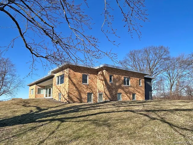 a view of a house with a snow on the road